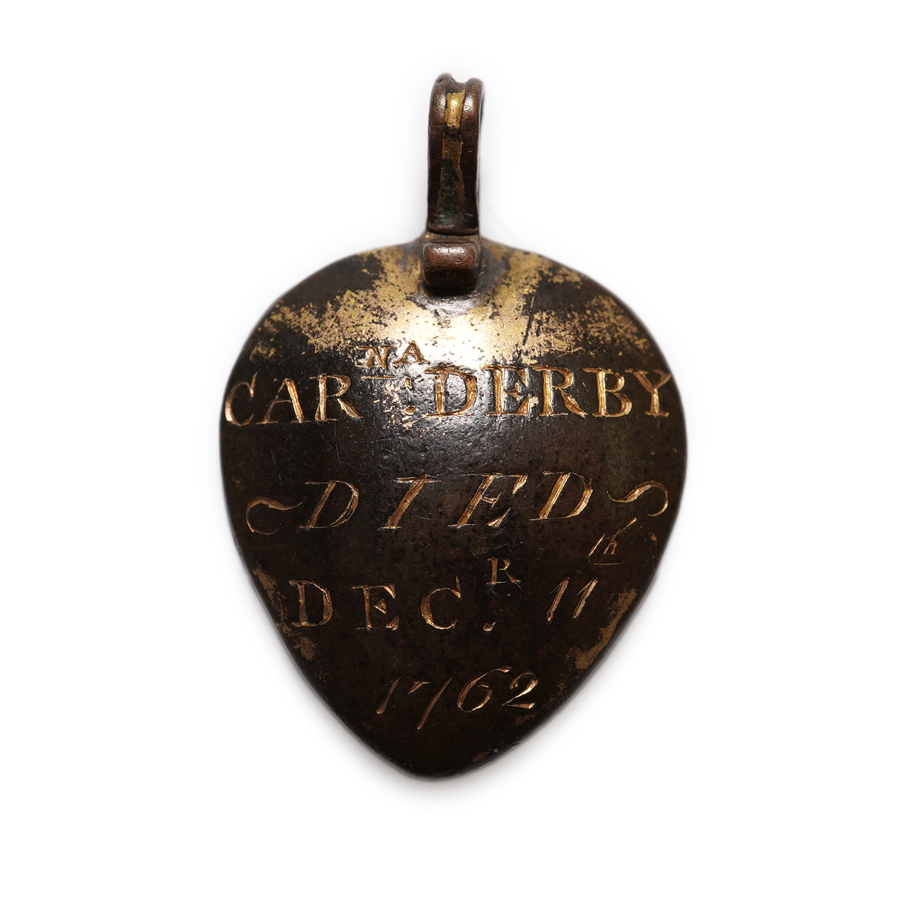 An 18th century gilt metal heart shaped mourning pendant, with engraved inscription, 'CARna DERBY DIED DEC 11th, 1762' and plaited hair beneath a glazed panel verso, 27mm.